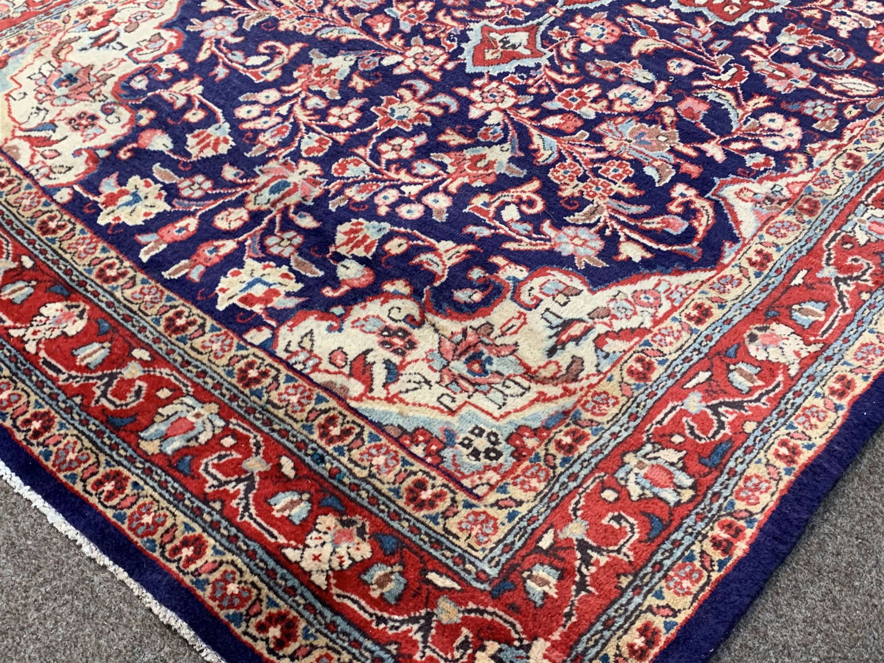 Persian Kashan ground rug, floral medallion on blue field with all over