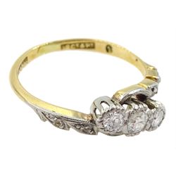 Gold three stone diamond crossover ring, with diamond set shoulders, stamped 18ct Plat, total diamond weight approx 0.30 carat