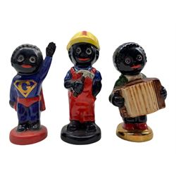 Three Carlton Ware Gollies, Superman, Builder and another playing the accordion  H9.5cm max (3)