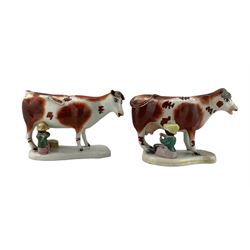 Two Victorian Staffordshire cow creamers, each naturalistically modelled with a milkmaid seated to one side with pail, on shaped rectangular bases, H14.5cm x W19cm max 