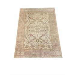 Pakistani beige ground carpet, interlaced trailing foliate and bordered 260cm x 350cm