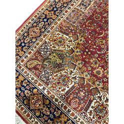 Persian design red ground rug, the field decorated with a central floral medallion and surrounded by alternating Boteh and palmette motifs, the guarded indigo border with repeating foliate patterns