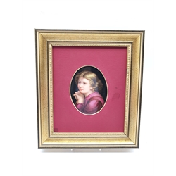 Continental oval porcelain plaque painted with a head and shoulders portrait of a child and inscribed in pencil to the reverse in a gilt frame 12cm x 9cm