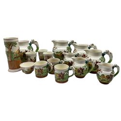 Quantity of Wedgwood Dye Ken John Peel pottery to include large and small jugs, beakers, cups and vase decorated with hunting scenes featuring hound handles (15) max H15cm