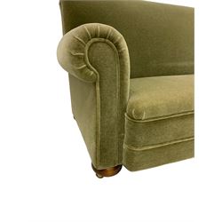 Victorian design two seat sofa, scrolled arms, upholstered in green fabric and raised on compressed bun feet with brass castors, with pair matching armchairs and footstool upholstered 