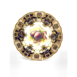 Royal Worcester hand painted cabinet plate by Albert Shuck c1925, centrally decorated with plums and raspberries against a cobalt blue ground with gilt highlights and raised gilt details to the border, D23.5cm