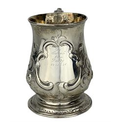 Early George III silver baluster mug with later embossed decoration and inscription, leaf capped scroll handle and gilded interior H12cm London 1764 Maker Benjamin Bickerton  