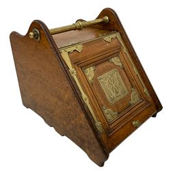 Late 19th century oak and brass mounted coal box with shovel, panelled hinged lid with central monogrammed brass plaque and geometric design spandrels, moulded and shaped end supports, with metal liner