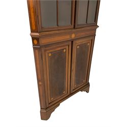 Edwardian Sheraton revival corner display cabinet, the broken arch pediment and dentil cornice over two astragal design glazed doors over two cupboard doors, raised on bracket supports 