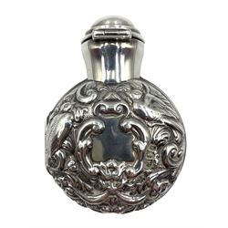 Late Victorian silver cased scent bottle, the hinged case chased with birds and scrolls, opening to reveal a green glass flask, the hinged cover locking in the glass stopper H7cm London 1897 Maker William Comyns