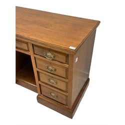 Edwardian walnut twin pedestal kneehole desk, rectangular top over central frieze drawer flanked by eight graduating drawers, on plinth base