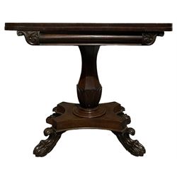 Victorian mahogany fold over tea table, the fold over top raised on octagonal column, leading to base with paw feet