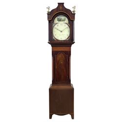 George IV mahogany longcase clock of small proportions by William Dixon of Pickering c1825,  with an ogee shaped pediment and twin eagle finials, satinwood crossbanding with oval conch shell inlay, break arch hood door and flanking pillars with brass capitals, mahogany trunk with inlaid canted corners and conforming break arch door, on a square plinth with inlay and splayed bracket feet, painted dial with geometric spandrels and depiction of a highland solder to the break arch, with upright Arabic numerals, minute track and matching stamped brass hands, dial inscribed “Wm. Dixon, Pickering”, dial pinned to a chain driven thirty hour countwheel striking movement striking the hours on a bell. With weight and pendulum. 
William Dixon was apprenticed in 1788 to Richard Scurr of Thirsk, then recorded as working in his own right from Boroughgate, Pickering, 1804-40