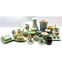 A collection of Radford hand-painted pottery to include a trio of Crocus shaped vases, preserve jars, two butter dishes, two tall vases, ashtray, three piece cruet on stand, basket etc (23)