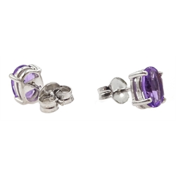 Pair of 9ct white gold oval amethyst stud earrings and a 9ct gold amethyst and diamond pendant, all hallmarked