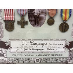French framed World War I memorial to Jean Louis Lauvergne comprising War Medal, Victory Medal, Verdun Medal and Croix de Combattants together with a photograph 'En Memoire de la Grande Guerre' 45cm x 55cm 