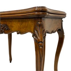 Victorian figured walnut games table, shaped and moulded fold-over top with quarter matched veneers, the sunken interior fitted with baize playing surface, pull-out action base revealing storage compartment, the frieze rail mounted by carved rose with foliage and extending flower heads, on leaf carved and moulded cabriole supports