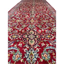 Persian red ground runner, the field decorated with overall floral Herati design, three-band border, the central band with repeating pattern decorated with stylised flowerhead and leaf motifs