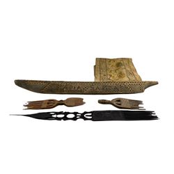 Samoan carved wooden model of a canoe L82cm, Tribal carved wooden forks and comb and a textile panel
