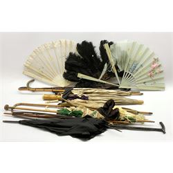A group of early 20th century parasols including an ivory handled example, bamboo and others, together with three fans including a black ostrich feather fan with faux tortoiseshell sticks  