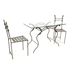 Blacksmith made wrought metal garden suite, comprising a table with glass top raised on spiralled, scrolled and serpentine rod base, together with a pair of matching chairs 