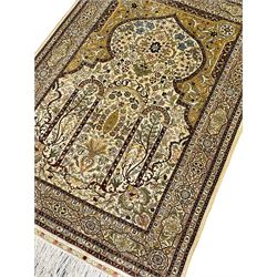 Fine silk Persian Hereke rug, the mihrab enclosing intricate floral design with urn, the main border band decorated with multiple shaped panels decorated with flowers, with signature panel 