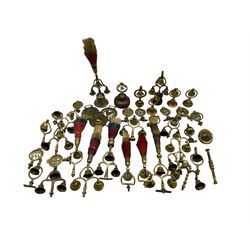 A collection of Horse Harness Swingers or Terrets, mostly brass triple bell terrets, seven with tricolour horse hair plumes, some horse brasses etc 