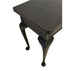 Mid-20th century black and waxed finish walnut tea table, fold-over swivel top with rounded corners revealing walnut surface, fitted with two drawers, on cabriole supports