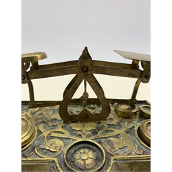 Set of late Victorian brass postal scales with cut leaf decoration 'Warranted Accurate' with four weights