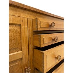 Beaverman - oak sideboard, rectangular adzed top over five graduating drawers flanked by panelled cupboards, fitted with Yorkshire Rose carved handles, panelled sides, carved with beaver signature, by Colin Almack, Sutton-under-Whitestone Cliffe, Thirsk