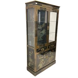 Chinese black lacquered and gilded display cabinet, fitted with two glazed doors, opening to reveal two adjustable glass shelves above two drawers and cupboards, with interior light, raised on a plinth base 