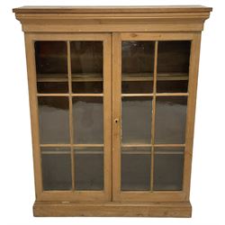 19th century and later pine display cabinet, the rectangular top over two astragal glazed doors, on moulded plinth base