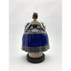 Harry Parr (1882-1966):  Chelsea pottery figure of an elegant lady in a blue dress holding a rose inscribed 'Hy. Parr, Chelsea 1923' on a circular wooden base H28cm (restored)