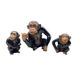 Sylvac model of a seated monkey holding a piece of fruit H17cm and two smaller Sylvac monkeys 