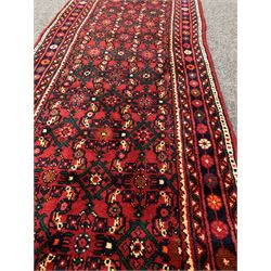 Persian Hamadan red ground runner, decorated with an all over floral design 477cm x 82cm