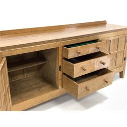 Peter 'Rabbitman' Heap of Wetwang - Yorkshire oak sideboard, raised back and adzed detailed top, two panelled cupboard doors flanking three graduating drawers, raised on stile supports featuring rabbit signature (W183cm, H80cm, D46cm)

