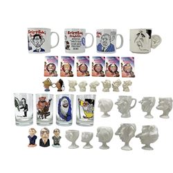 Group of Spitting Image ceramics, glass and other memorabilia, including seven Luck & Flaw Spitting Image pottery egg cups of the Royal family, including Queen Elizabeth II, Prince Philip, Prince Charles, Dianna Princess of Wales x2, Prince William, Prince Harry, Sarah Ferguson, a Ronald Reagan mug; set of four glass tumblers, four mugs, various magnets and other porcelain political caricature figures