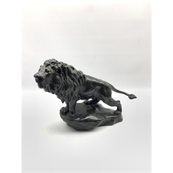 Early 20th century bronzed lion standing on rocky base after Gyorgy Vastagh, signed in the cast 44cm x 32cm