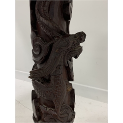  Early 20th century Chinese hardwood occasional table, the top with bone inlay over turned column decorated with carved dragon, raised on triple splay supports, D55cm  