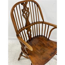 Pair of elm and oak Windsor armchairs, double hoop and high stick back, shaped splat with pierced decoration, dished saddle type seat, on turned supports joined by crinoline stretcher 