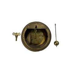 French clock movement housed in a wooden case with pendulum and key.