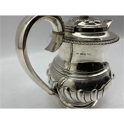 George IV silver coffee pot of baluster design with leaf capped handle, vacant heart shape cartouches, compressed circular lift and gadrooned border on a short pedestal foot H21cm London 1821 Maker Crespin Fuller 26.5oz
