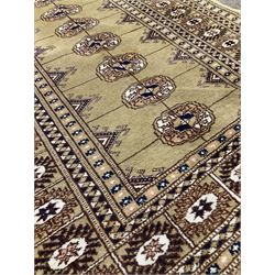 Small beige Bokhara rug with one central line of Gul motifs surrounded by border  