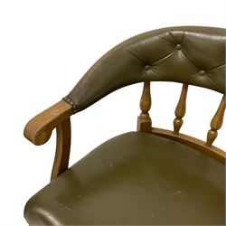 Mid-20th century oak framed tub-shaped desk chair, upholstered in buttoned green fabric, on turned supports united by x-shaped stretchers