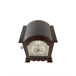 French - Small mahogany cased 8-day mantle clock c1905, with a break arch pediment and conforming fully glazed door with a silvered slip, on a shaped base with bracket feet, silvered sheet dial and chapter ring with engraved Roman numerals, minute hands and steel gothic hands, Parisian rack striking movement with a lever platform escapement, striking the hours and half hours on a coiled gong. with key.
