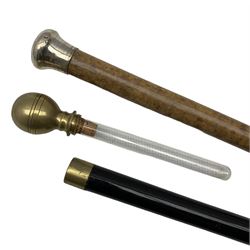20th century malacca walking cane with silver pommel by Henry Perkins and an ebonised sectional cane inset with a glass tube (2)