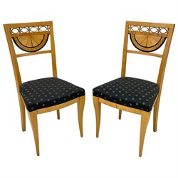 Pair Biedermeier design maple side chairs, the cresting rail with pierced decoration over demi-lune fan back with figured band, upholstered in black fabric decorated with stairs, on tapering supports