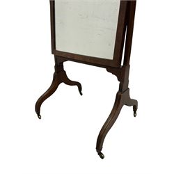George III mahogany cheval mirror, urn finials over square uprights, the rectangular swing mirror with adjustable brass handles to the side, raised on splayed reeded supports with brass castors
Provenance: From the Estate of the late Dowager Lady St Oswald