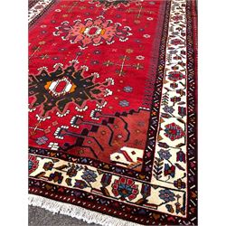Persian Hamadan red round rug, triple medallion and stylised foliate enclosed by ivory border 256cm x 162cm