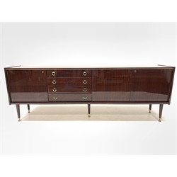 Mid Century retro Italian mahogany veneered Vintage sideboard, circa 1970s, fitted with four drawers flanked by two cupboards, each enclosing a single shelf, raised on turned supports terminating in brass feet, W241cm, H86cm, D47cm